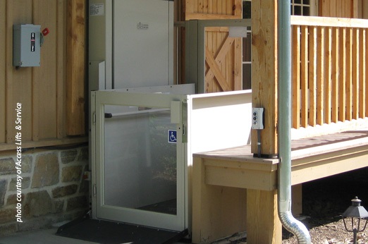 Wheelchair lift installed at the entrance of a building to provide accessibility.