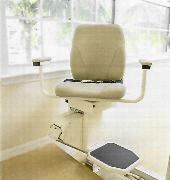 Stair lift chair installed in a home with large windows in the background.