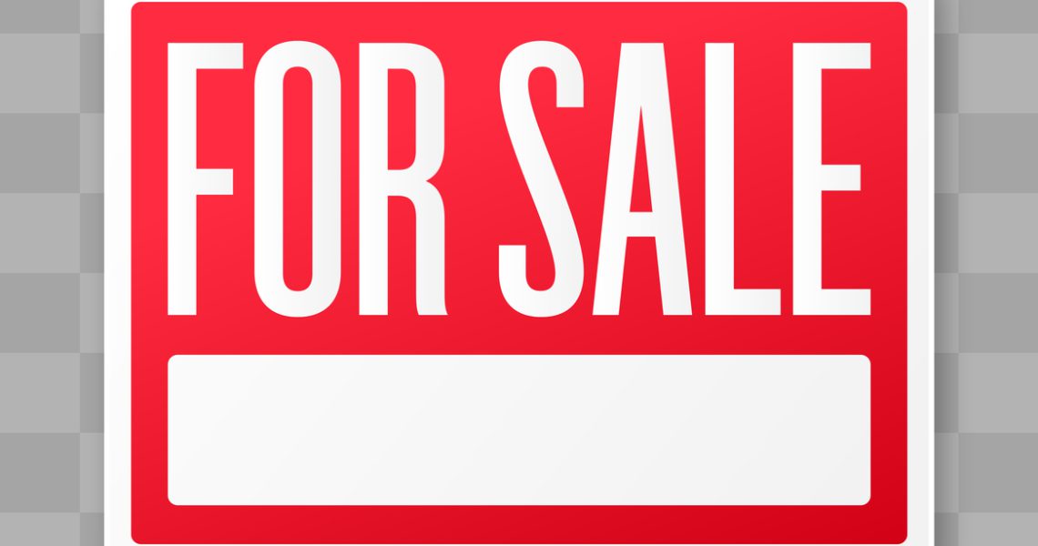 Red "for sale" sign with white lettering.