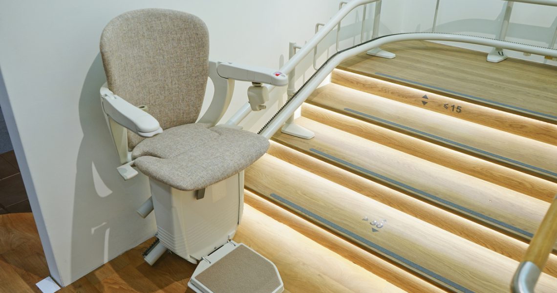 Stairlift installed next to a staircase in a home.